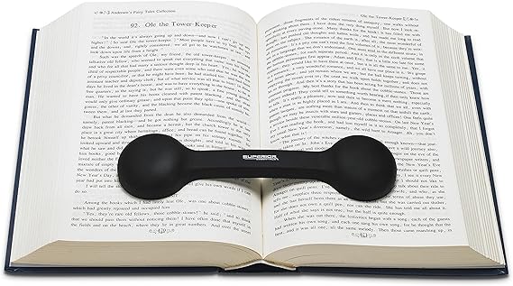 Book weight stretched across hardcover book holding pages open